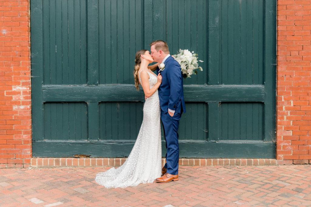 Erin and Stephen share a kiss next to the Linden Row Inn on their wedding day. 