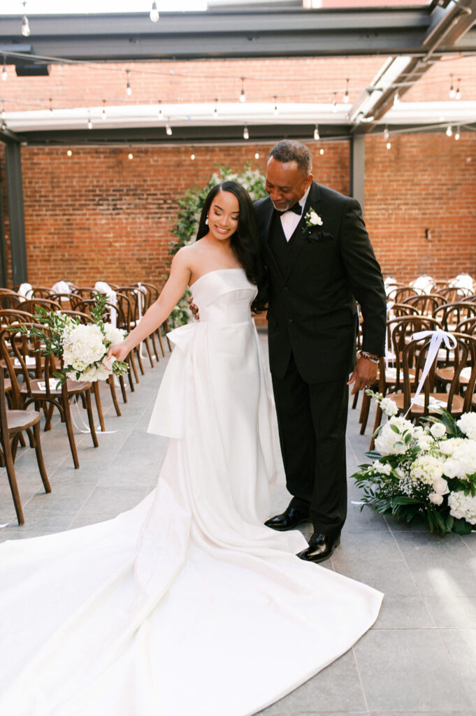 The bride sharing a sweet moment with her father in the courtyard ceremony space at her Common House Richmond wedding, photographed by Chelsea Schmidt Photography.