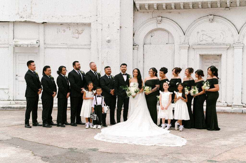 Full wedding party portrait with bridesmaids, groomsmen, and flower children at Gabriela and David’s Common House Richmond wedding by Chelsea Schmidt Photography.